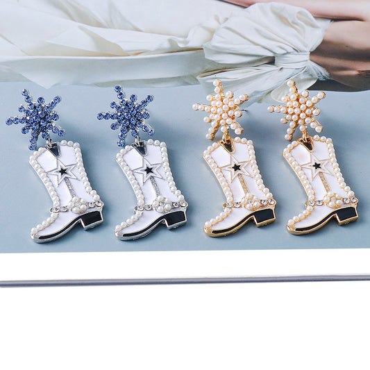 A set of four dangle earrings designed to resemble cowboy boots, with blue and clear rhinestones on a white alloy base.
